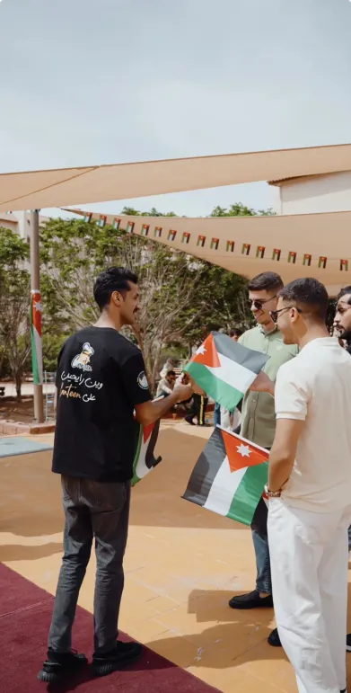 Canteen team handing out flags on campus